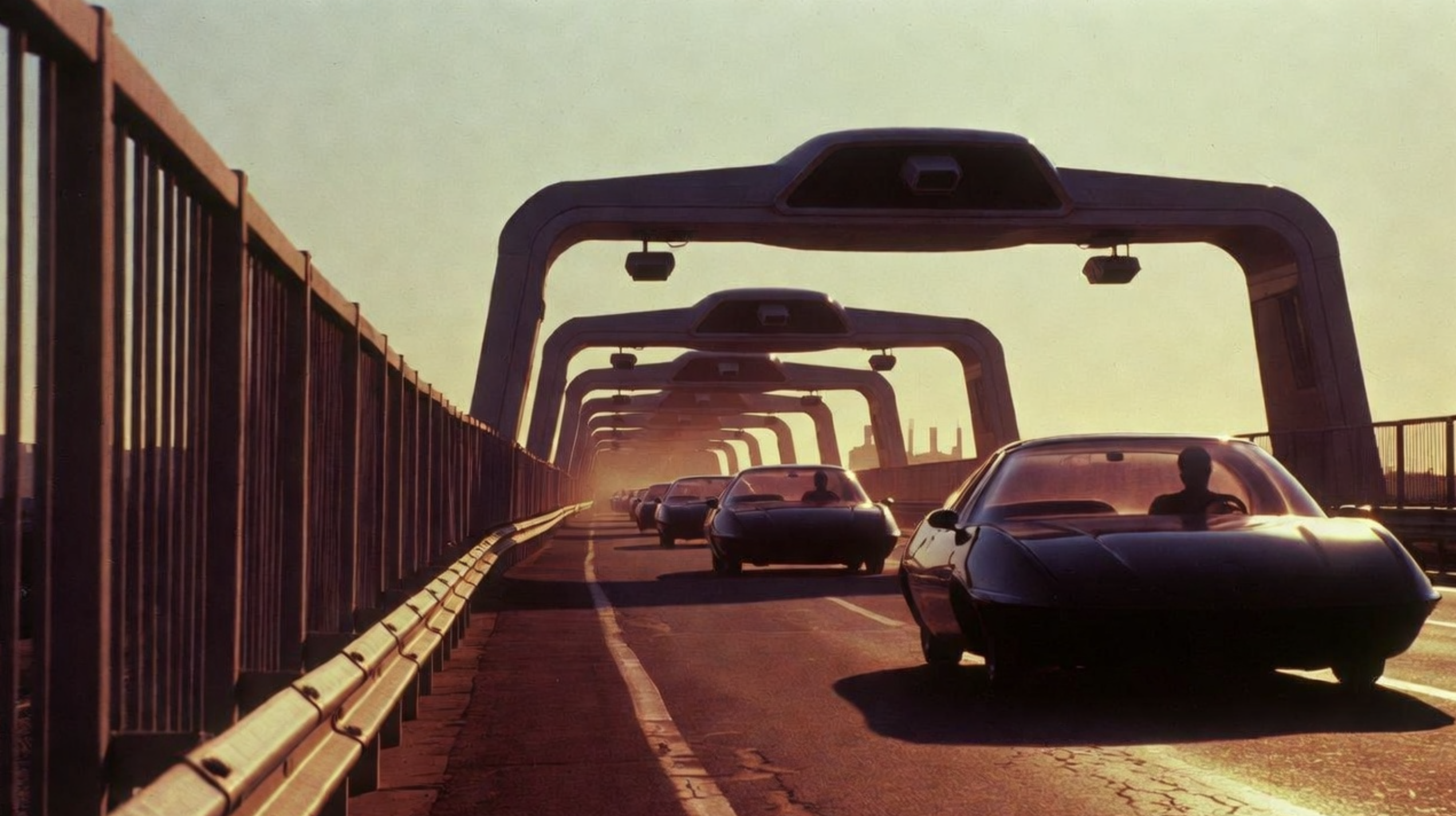 A road with futuristic cars driving on a high way with rails and cameras overhead scanning cars to ensure they are where they're supposed to be.