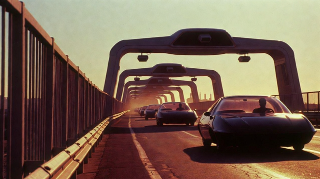 A road with futuristic cars driving on a high way with rails and cameras overhead scanning cars to ensure they are where they're supposed to be.